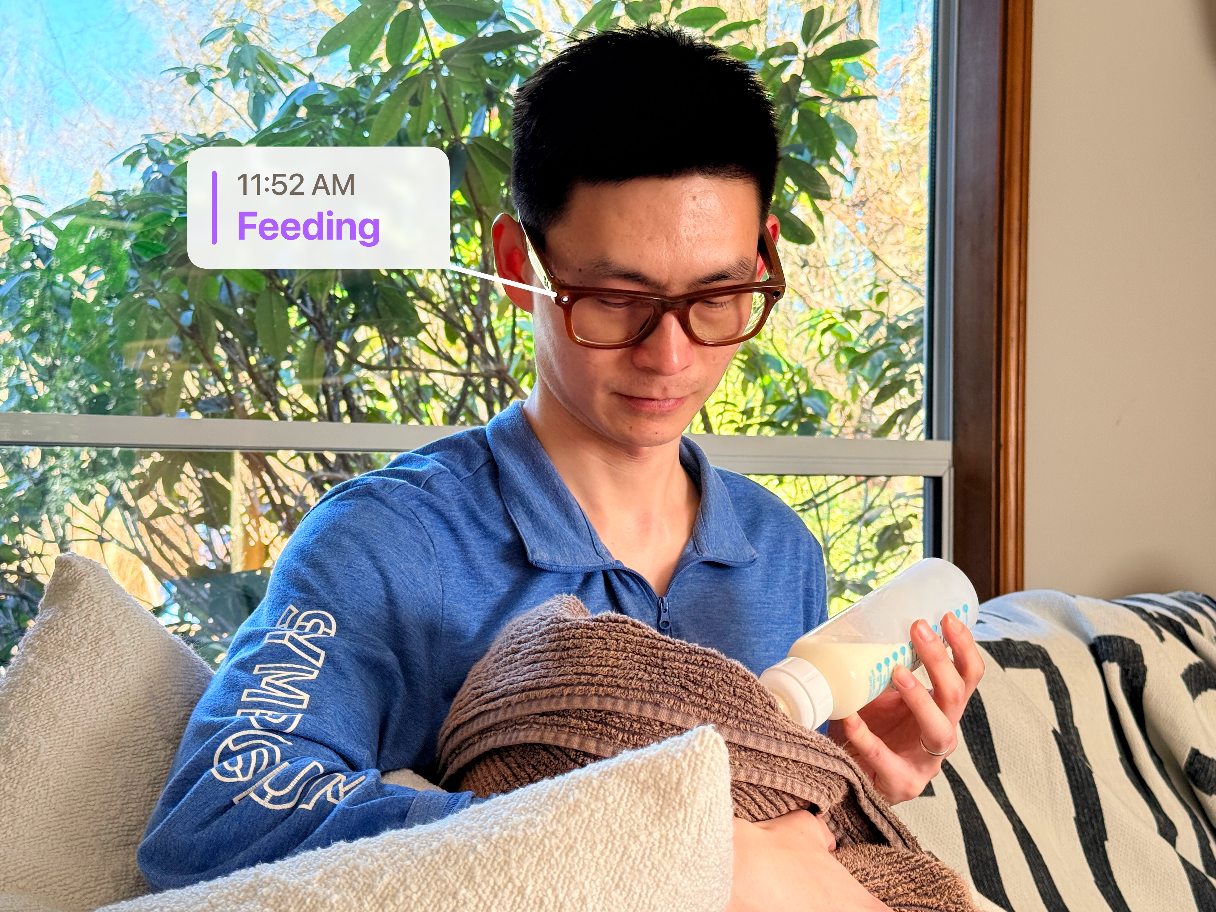 Parent wearing Ray-Ban Meta glasses feeding a newborn with a BabyCare activity label overlay.